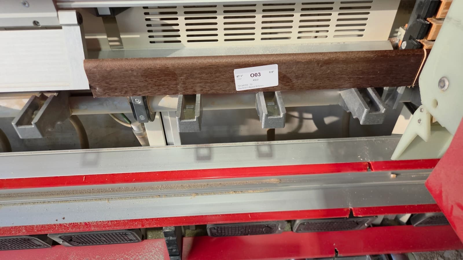 Battiscopa in legno etichettato O03 posizionato nella macchina in laboratorio
